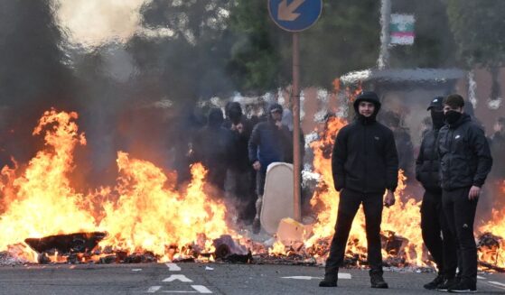 Youths gather in front of a burning barricade Wednesday in Belfast, Northern Ireland.