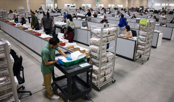 Workers count ballots on June 3 at the ballot processing center in City of Industry, California.