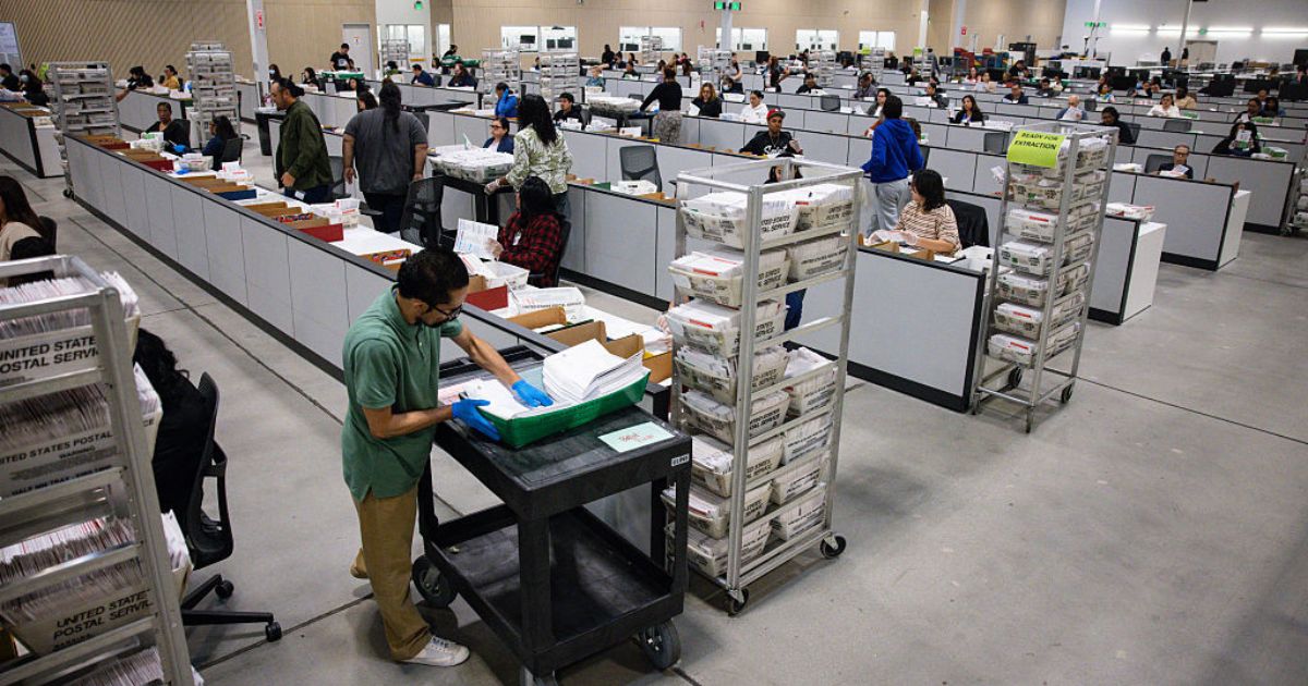 Workers count ballots on June 3 at the ballot processing center in City of Industry, California.