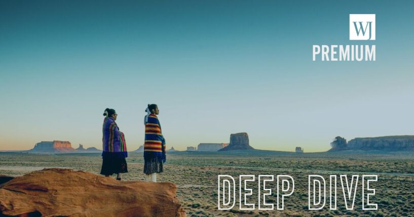 Navajo girls wrapped in handwoven traditional blankets enjoying a grand sunrise in Monument Valley.