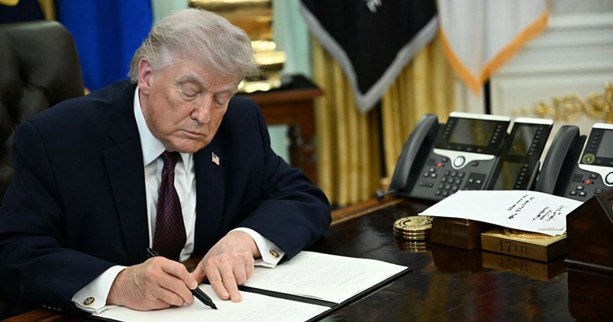President Donald Trump is pictured in a March 31 photo signing an executive order in the Oval Office of the White House.