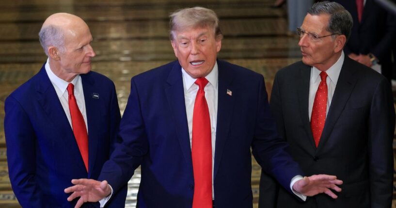 President Donald Trump speaks to the media on Capitol Hill Wednesday, flanked by GOP Sens. Rick Scott of Florida, left, and Senate Majority Whip John Barrasso of Wyoming.