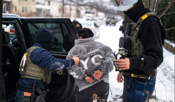 A man is detained by a Border Patrol agent in a file photo dated Jan. 21 in Minneapolis, Minnesota.
