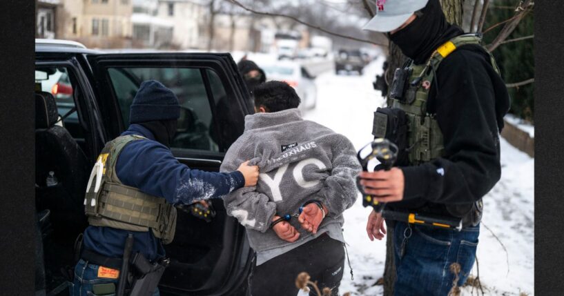 A man is detained by a Border Patrol agent in a file photo dated Jan. 21 in Minneapolis, Minnesota.