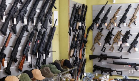Guns are displayed on a shop’s wall.