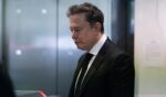 Elon Musk walks into an elevator at the Ronald V. Dellums Federal Court Building on April 28, 2026.