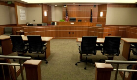 A modern courtroom sits empty under dim lights.