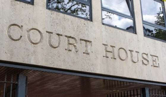 The lettering of a court house is shown on the concrete wall of a courthouse.