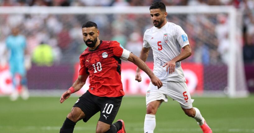 Mohamed Salah, playing for Egypt, and Milad Mohammadi, playing for Iran, play on a soccer field in Seattle, Washington on June 26, 2026.