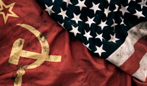 Muddied USSR and American flags lay next to each other.
