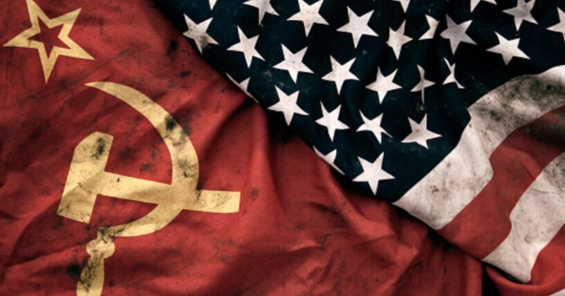 Muddied USSR and American flags lay next to each other.