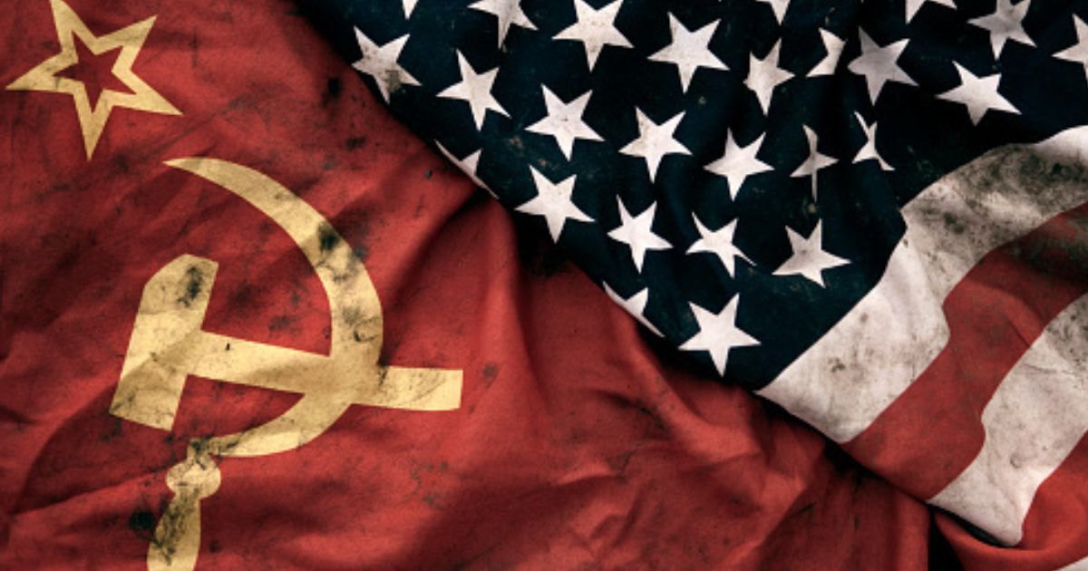 Muddied USSR and American flags lay next to each other.
