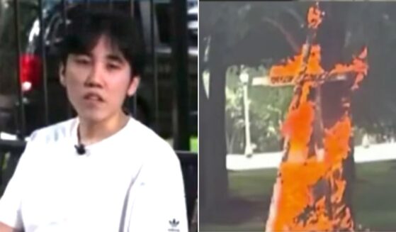 A young liberal identified as Merlin Lu, 21, told a Chicago TV station he burned the cross to protest the Trump administration.