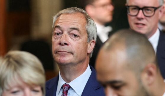 Reform UK leader Nigel Farage walks through the House of Commons at the Palace of Westminster in London on May 13, 2026.