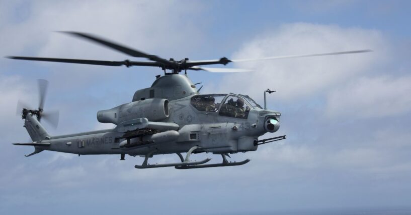 A U.S. Marine Corps AH-64 Apache helicopter flies through the sky on April 29, 2018.