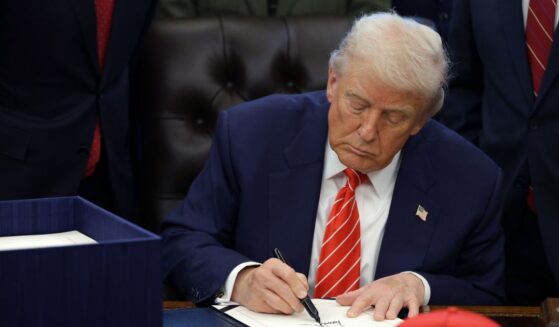 President Donald Trump signs a bill in the Oval Office of the White House on Feb. 3, 2026 in Washington.