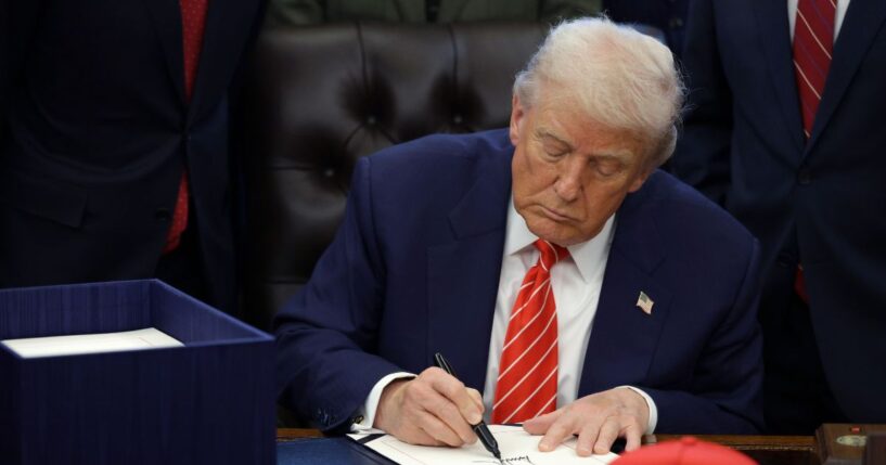 President Donald Trump signs a bill in the Oval Office of the White House on Feb. 3, 2026 in Washington.