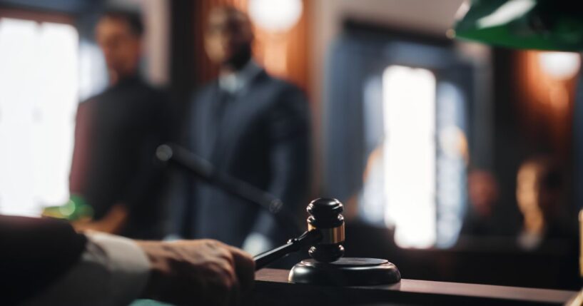 A judge strikes with his gavel in a courtroom.