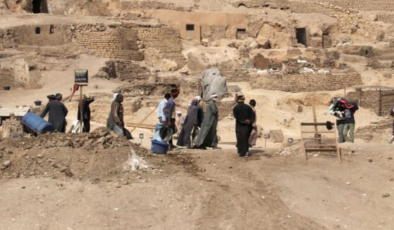 Workers walk through an archeological site in Egypt in February of 2018.