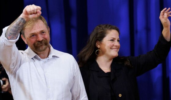 Democratic Maine U.S. Senate candidate Graham Platner and his wife Amy Gertner wave to supporters as they arrive at Platner's Primary Election event on June 9 in Blue Hill, Maine.