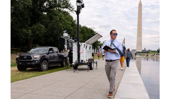 U.S. Park Police and contractors place security cameras along the Lincoln Memorial Reflecting Pool Thursday in Washington, D.C.