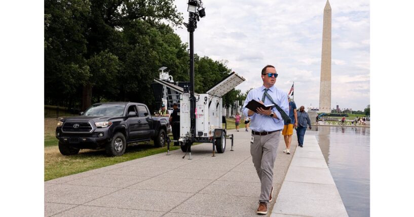 U.S. Park Police and contractors place security cameras along the Lincoln Memorial Reflecting Pool Thursday in Washington, D.C.