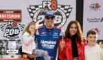 Kyle Busch, driver of the HendrickCars.com Chevrolet, celebrates with his children and wife, Samantha Busch, in victory lane after winning the NASCAR Craftsman Truck Series Fr8 Racing 208 at Echo Park Speedway on Feb. 21, 2026, in Hampton, Georgia.