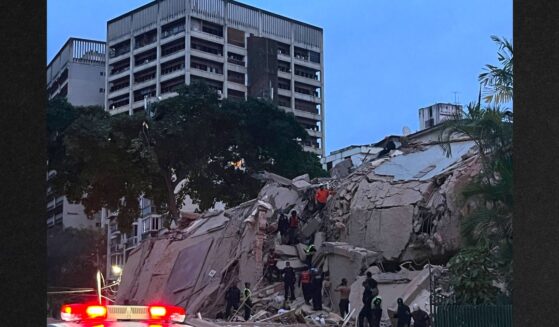 Rescuers search for victims in a collapsed building following an earthquake in Caracas Wednesday evening. A magnitude 7.1 earthquake struck Venezuela on Wednesday, the United States Geological Survey reported, triggering panic in Caracas, according to AFP journalists.