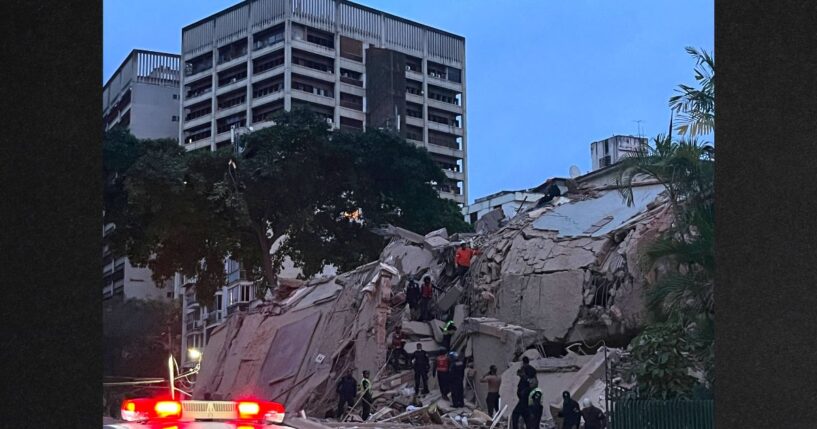 Rescuers search for victims in a collapsed building following an earthquake in Caracas Wednesday evening. A magnitude 7.1 earthquake struck Venezuela on Wednesday, the United States Geological Survey reported, triggering panic in Caracas, according to AFP journalists.