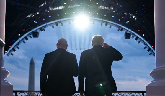 President Donald Trump and UFC CEO Dana White stand on the Blue Room Balcony of the White House as military jets perform a flyover during the UFC Freedom 250 Fight on the South Lawn of the White House on June 14, 2026, in Washington, D.C.