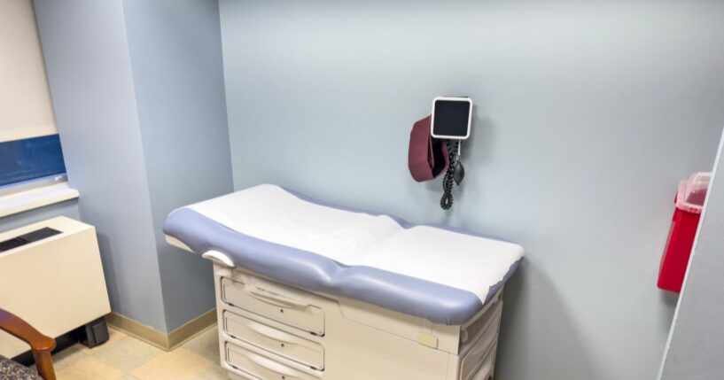 An empty examination table in a doctor’s office.