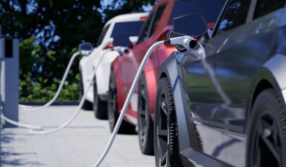 Generic electric cars charging on a city street.