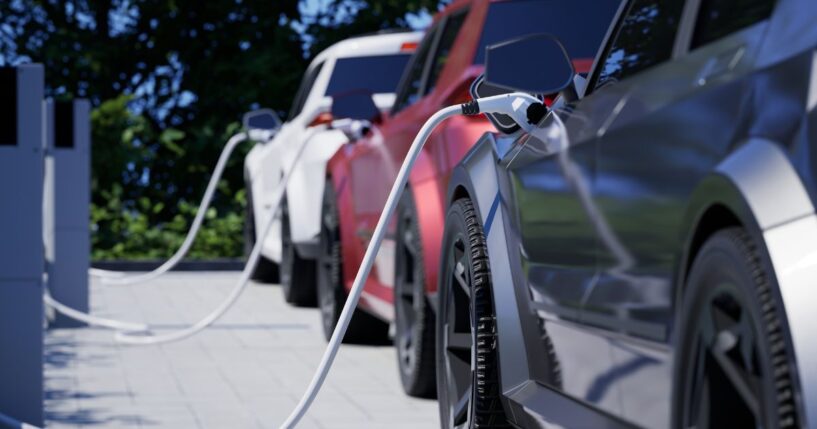 Generic electric cars charging on a city street.