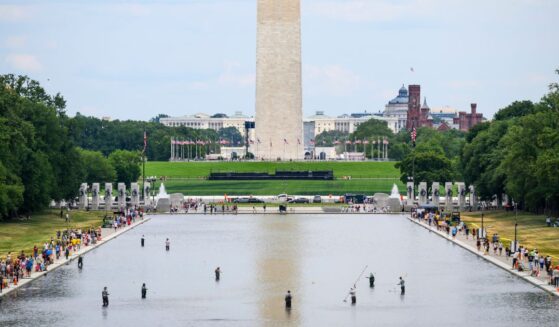 National Park Service personnel vacuum algae from the Reflecting Pool on June 21, 2026, in Washington, D.C.