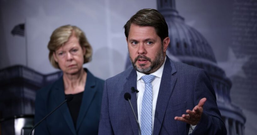 Sen. Tammy Baldwin listens as Sen. Ruben Gallego speaks during a news conference to introduce the Protect our Polls Act at the U.S. Capitol on June 18, 2026, in Washington, D.C.