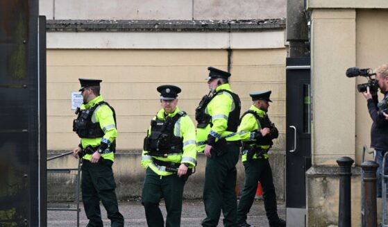 Police officers erect barriers as they prepare for the departure of Former DUP Leader Sir Jeffrey Donaldson from Newry court house on June 18, 2026, in Newry, Northern Ireland.