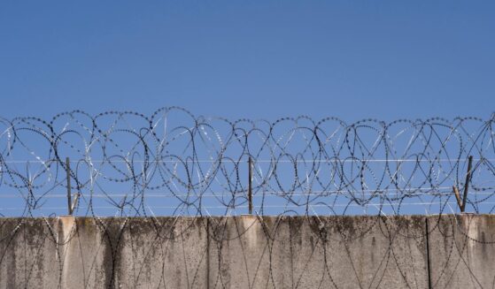 A prison wall with barbed wire in Frankfurt, Germany.
