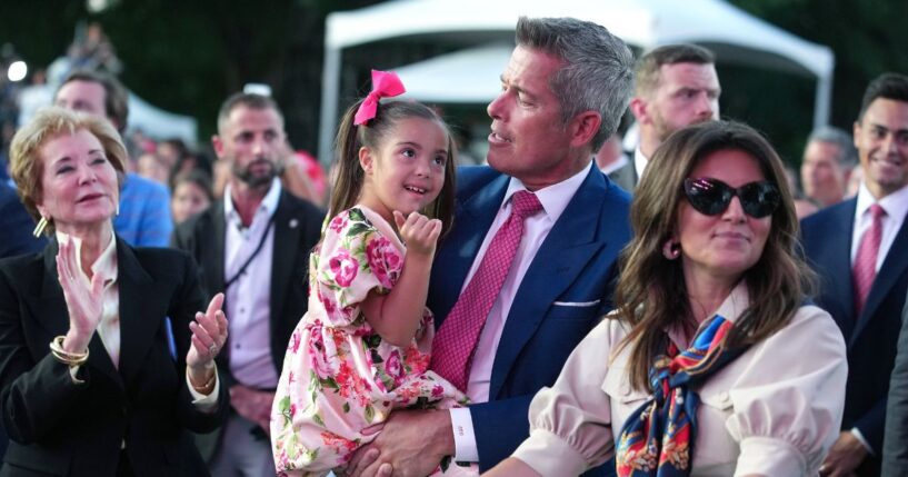Secretary of Transportation Sean Duffy holds his daughter during a rally to kick off the Great American State Fair on the National Mall on June 24, 2026, in Washington, D.C.