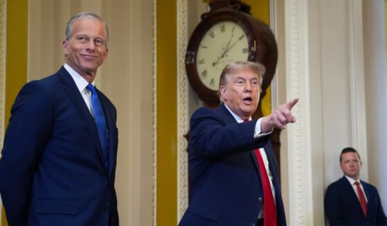 Senate Majority Leader John Thune watches as President Donald Trump speaks to the media as they arrive at the U.S. Capitol on June 24, 2026, in Washington, D.C.