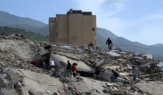 Volunteers search for possible victims amid the rubble following a twin earthquake in Caraballeda, La Guaira state, about 40 km northeast of Caracas, on June 25, 2026.