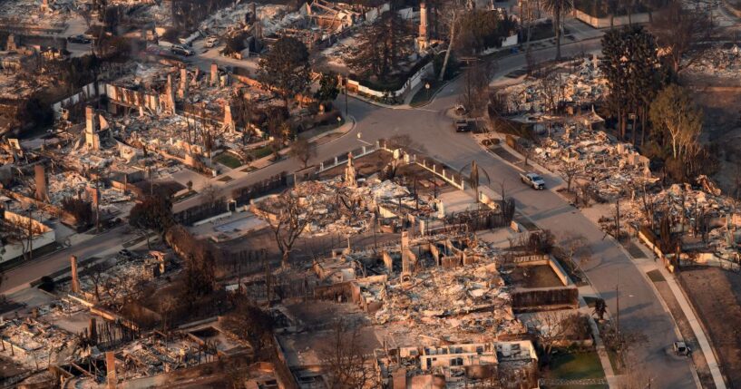 In this aerial view taken from a helicopter, homes burned from the Palisade fire smolder near the Pacific Palisades neighborhood of Los Angeles, California, on Jan. 9, 2025.
