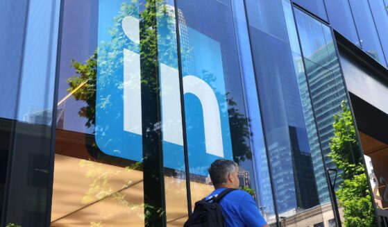 A pedestrian walks by a sign at a LinkedIn office on July 26, 2023, in San Francisco, California.
