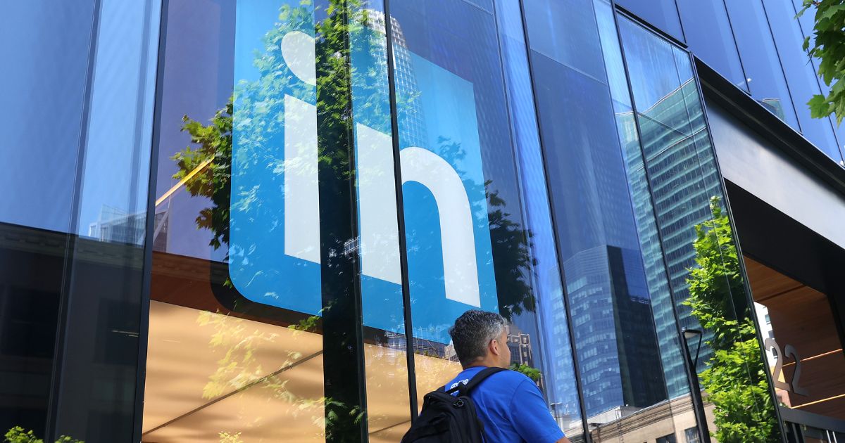 A pedestrian walks by a sign at a LinkedIn office on July 26, 2023, in San Francisco, California.