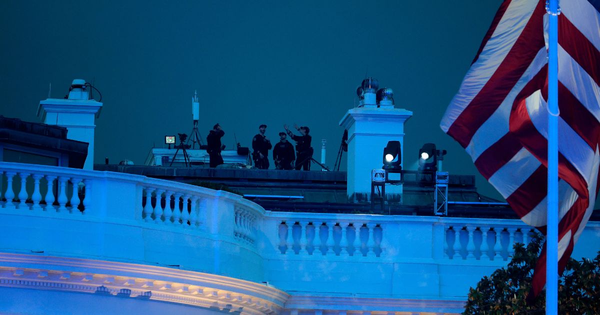 Secret Service agents are seen atop the White House during UFC Freedom 250 on the South Lawn on June 14, 2026, in Washington, D.C.