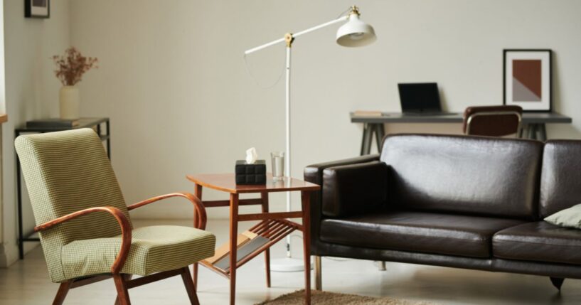 A modern interior of a psychologist office with a comfortable sofa and armchair.