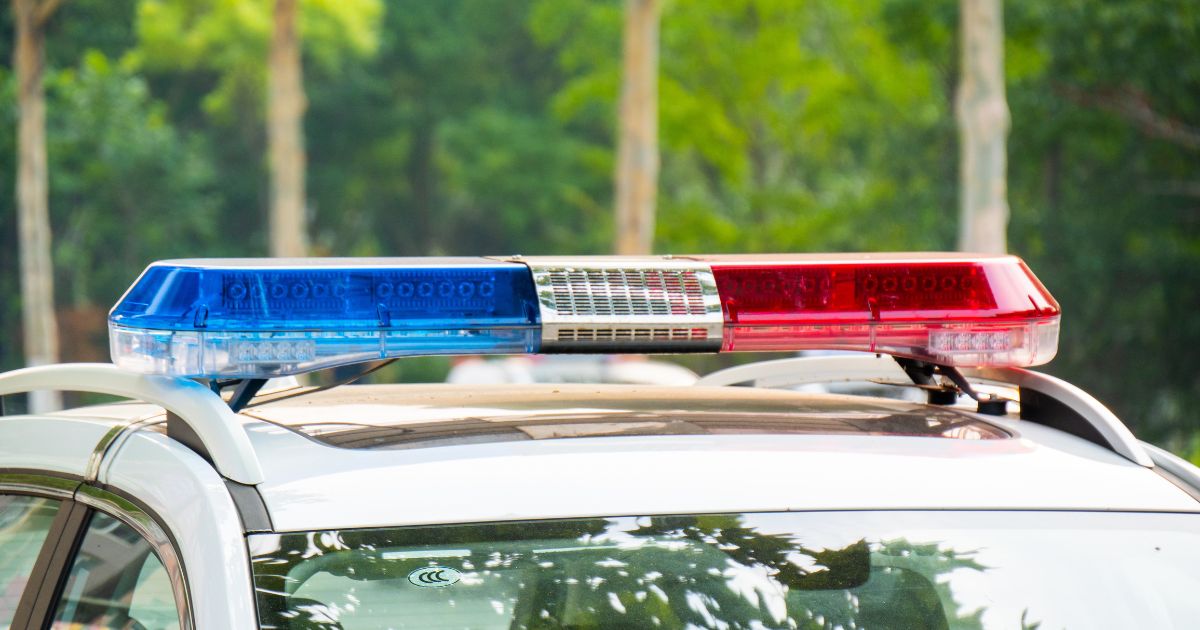 Police lights on a car during traffic surveillance on the city road.