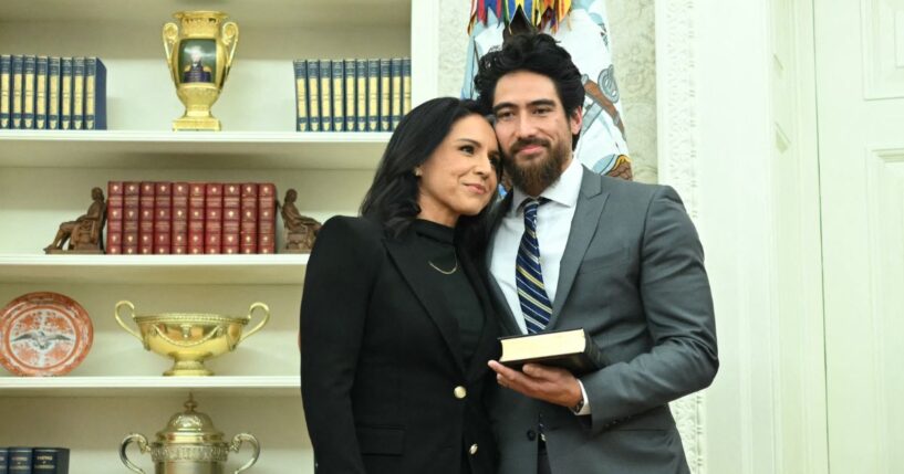 Tulsi Gabbard and her husband, Abraham Williams, hug before she is sworn in as Director of National Intelligence in the Oval Office of the White House in Washington, D.C., on Feb. 12, 2025.