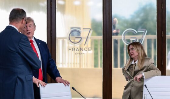 President Donald Trump speaks with German Chancellor Friedrich Merz next to Italian Prime Minister Giorgia Meloni at a working lunch with leaders of G7 and the Middle East, on June 16, 2026, in Evian-les-Bains, France.
