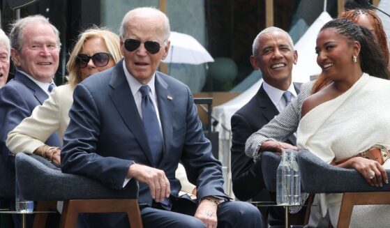 Former President Joe Biden listens to a performance by Stevie Wonder at the dedication ceremony for the opening of the Barack Obama Presidential Center in John Lewis Plaza on June 18, 2026, in Chicago, Illinois.