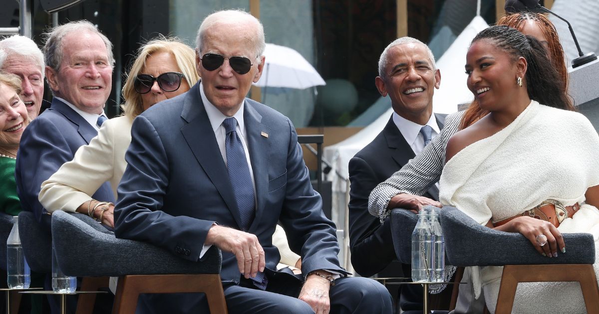 Former President Joe Biden listens to a performance by Stevie Wonder at the dedication ceremony for the opening of the Barack Obama Presidential Center in John Lewis Plaza on June 18, 2026, in Chicago, Illinois.